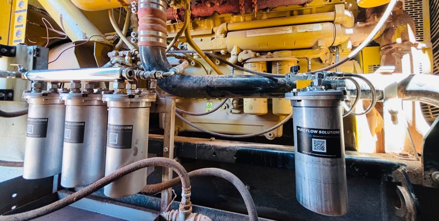 CAT engine bay with Pure Flow Solutions filtration hardware