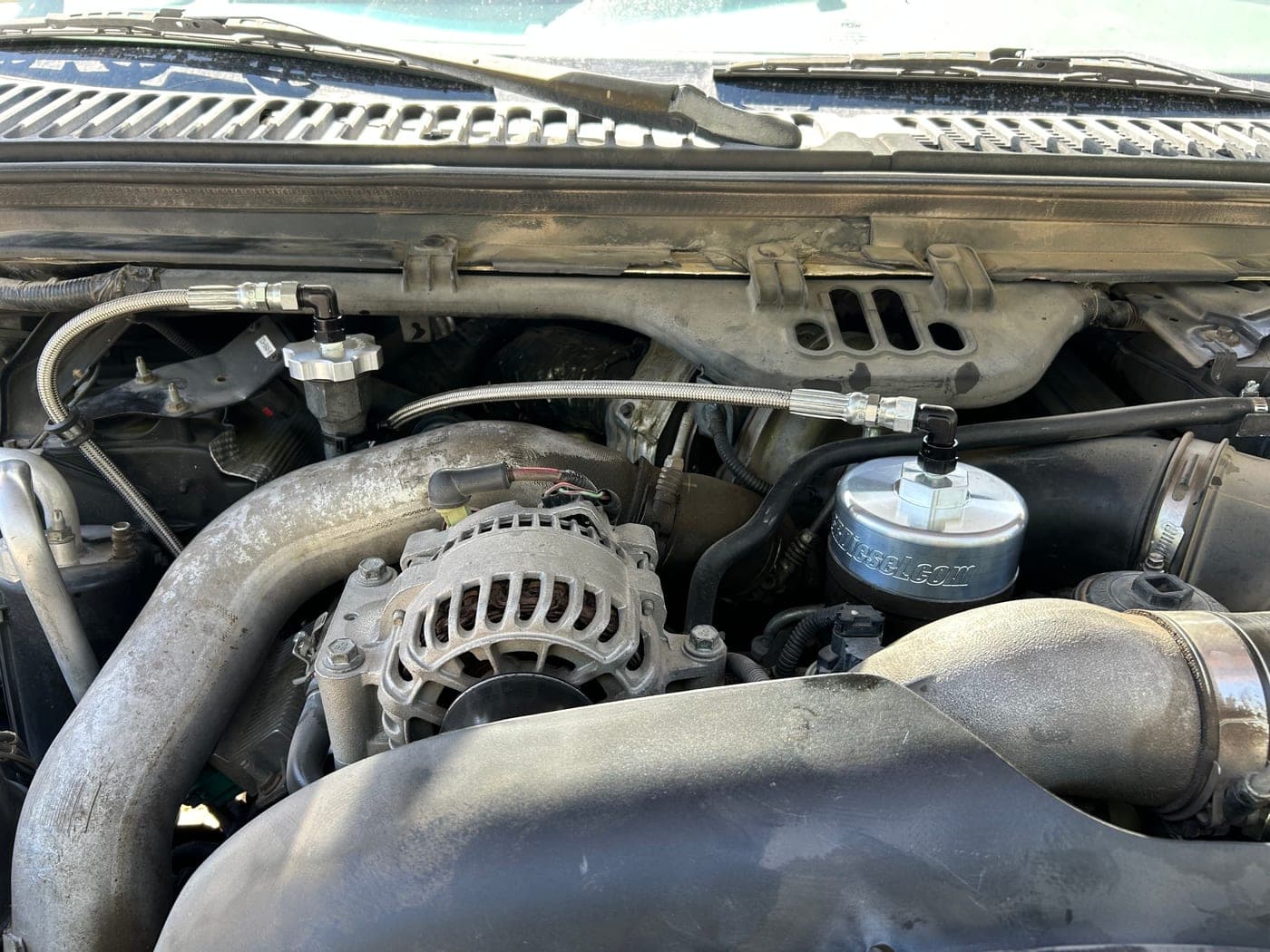 Heavy equipment engine with filtration plumbing