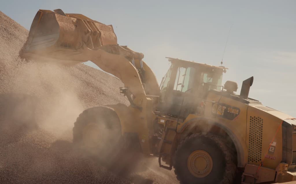 CAT 966M wheel loader working on a jobsite