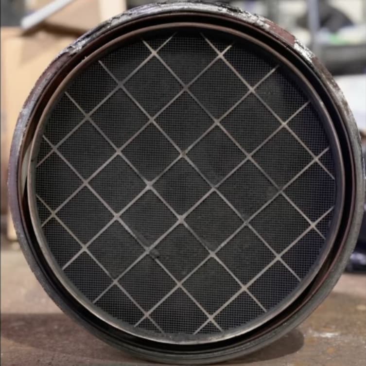 Soot-clogged DPF filter element with heavy carbon buildup blocking the honeycomb cells